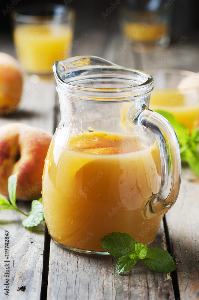 Fresh peach juice with mint on the wooden table Fresh peach juice with mint on the wooden table