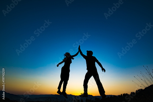 Konstfotografi Girl and man holding for hands and jumping