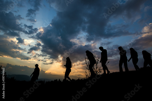 group of friends are walking in the nature sunset