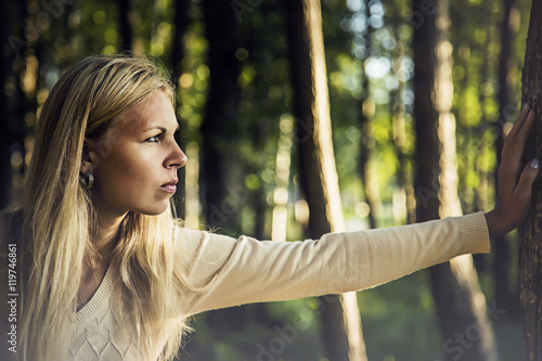 Young, beautiful woman thinking how to stop all the problems and anger in darkly atmosphere.