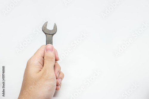 Hand holding wrench on white background