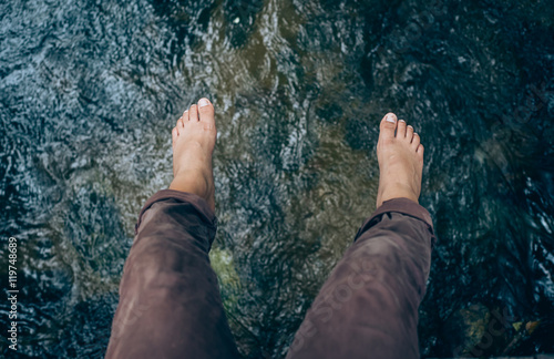 Wallpaper Mural Looking down on feet and a wooden surface, space for text. selective focus Torontodigital.ca