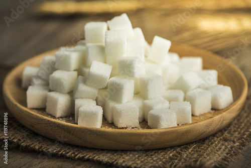 white sugar in a wooden plate photo