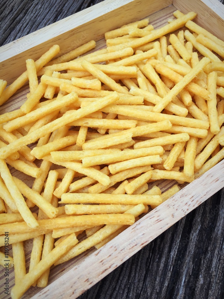 French-fries with ketchup on wood box French-fries with ketchup on wood box