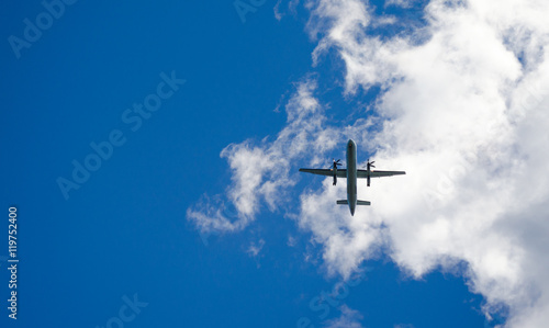 Blue sky fly-over. Aircraft on glide path to St John's airport, Newfoundland, Canada. An air plane passes overhead in sunny blue sky, landing in St. John's, Newfoundland.