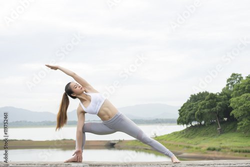 Woman practicing Yoga Extended right side angle pose in the morning