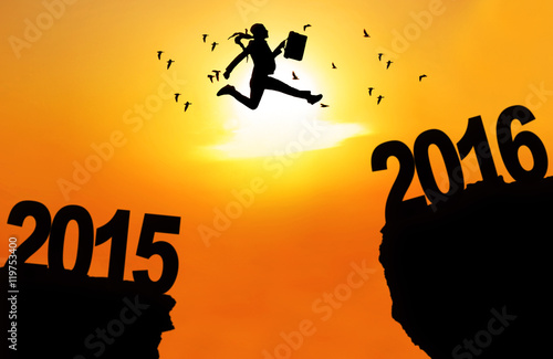 Businesswoman jump over cliff with numbers 2016