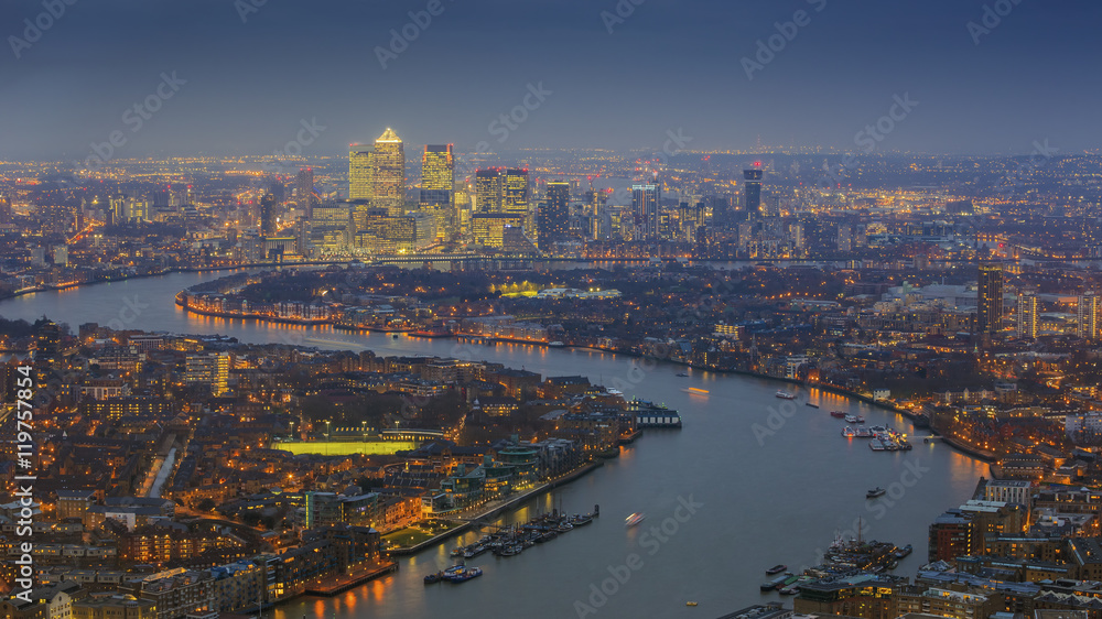 London, England - Panoramic skyline view of east London with the skyscrapers of Canary Wharf at blue hour