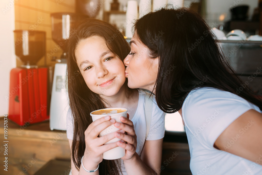 Mother and daughter drink espresso Mother and daughter drink espresso