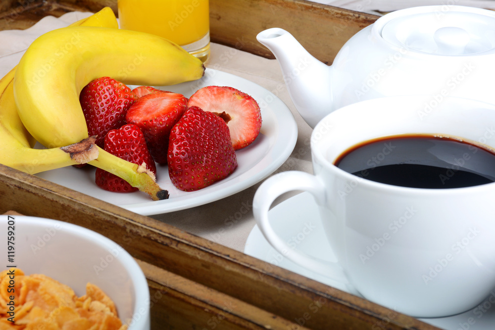 Breakfast tray with coffee, orange juice, cereals and fruits. Breakfast tray with coffee, orange juice, cereals and fruits.