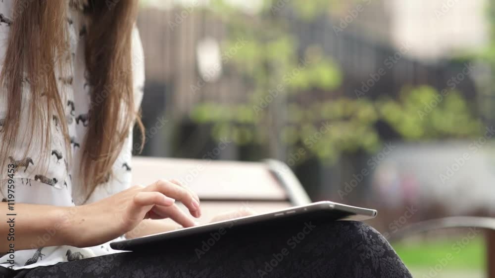 Women's hands with the black tablet. Uncertain woman uses touchscreen Women's hands with the black tablet. Uncertain woman uses touchscreen
