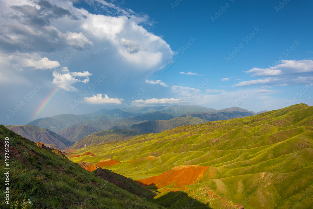 Beautiful mountain landscape with bright rainbow, Kyrgyzstan.