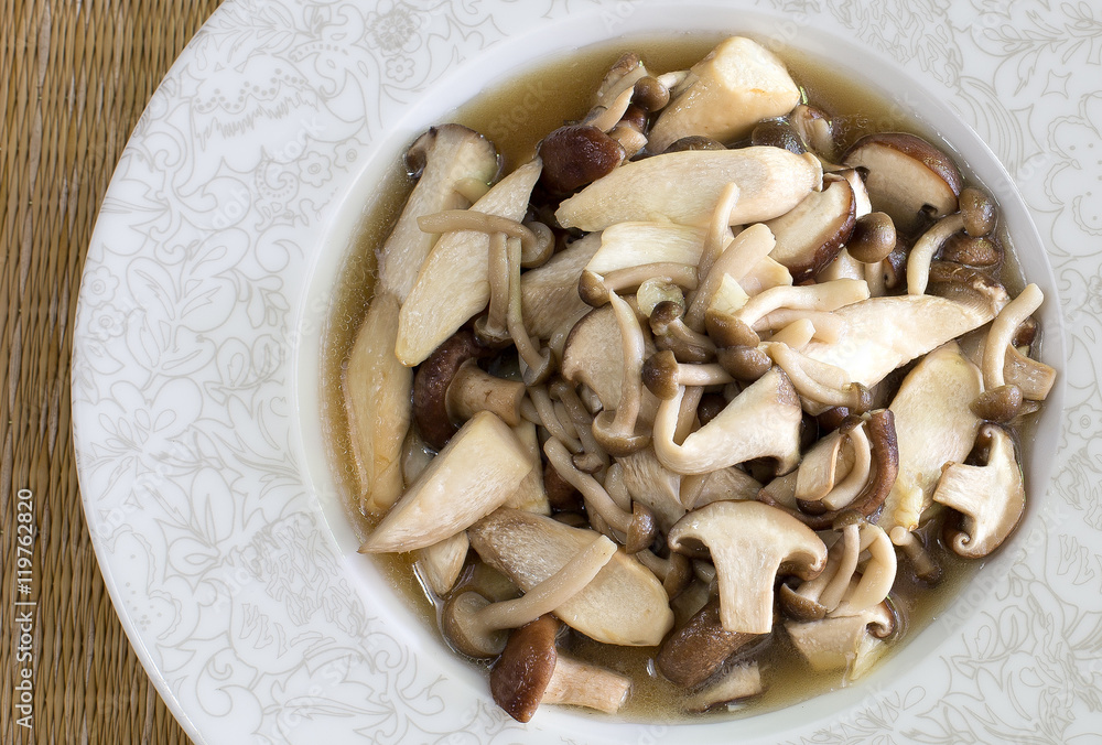 Stir fried mushroom in white dish on brown napery / Top view Ima Stir fried mushroom in white dish on brown napery / Top view Ima