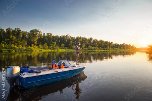Fotótapéta Mature man on a motor boat. Fishing.