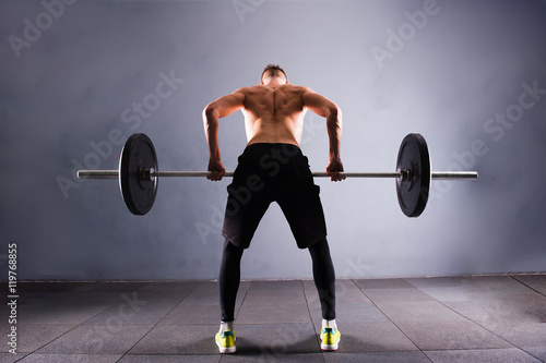 Crossfit fitness gym heavy weight lifting bar by strong man workout