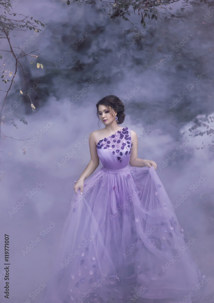 Beautiful, young, brunette in a luxurious, purple, long dress. Fairy Photo. Creative toning. Queen walking in the fog. Beautiful, young, brunette in a luxurious, purple, long dress. Fairy Photo. Creative toning. Queen walking in the fog.