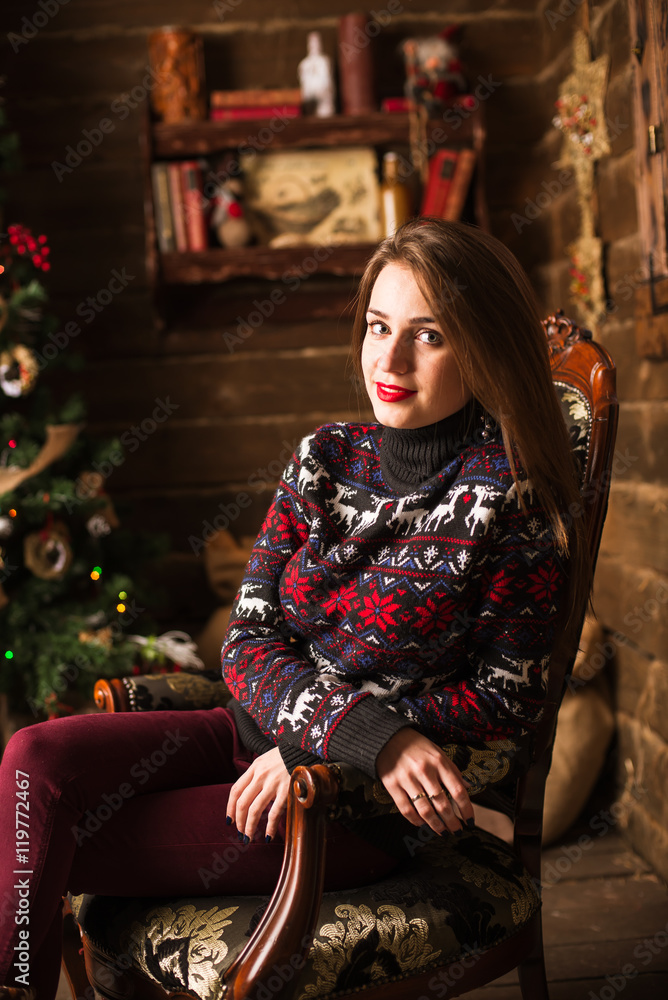 Young girl sitting next to Christmas tree and gifts Young girl sitting next to Christmas tree and gifts