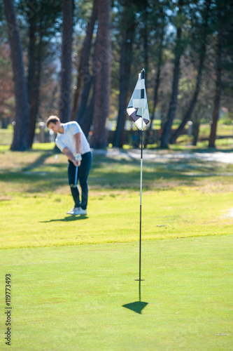 golfer playing a chip shot onto the green