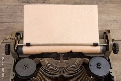 Vintage typewriter on the old wooden desk