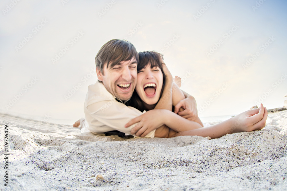 A loving couple fooling around on the sea A loving couple fooling around on the sea