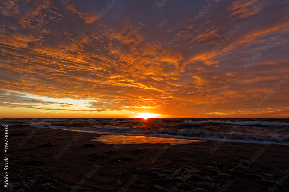 Orange sunset on the beach. Baltic Sea.
