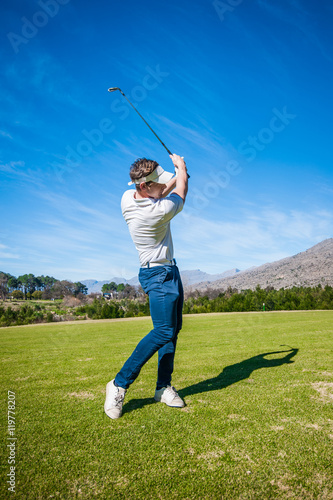 golfer playing a shot on the fairway