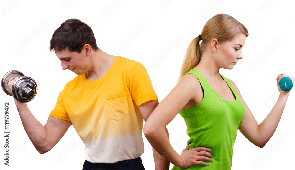 Couple exercising with dumbbells lifting weights Couple exercising with dumbbells lifting weights