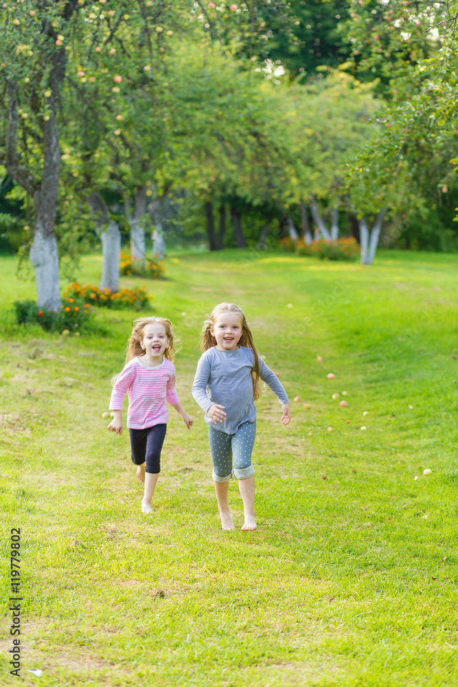 Fototapeta premium Two cute girls playing in the par