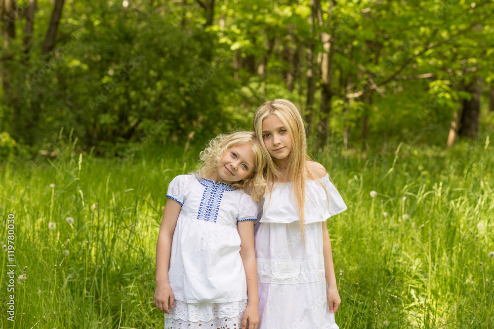 Two young girls relaxing on nature in summer Two young girls relaxing on nature in summer