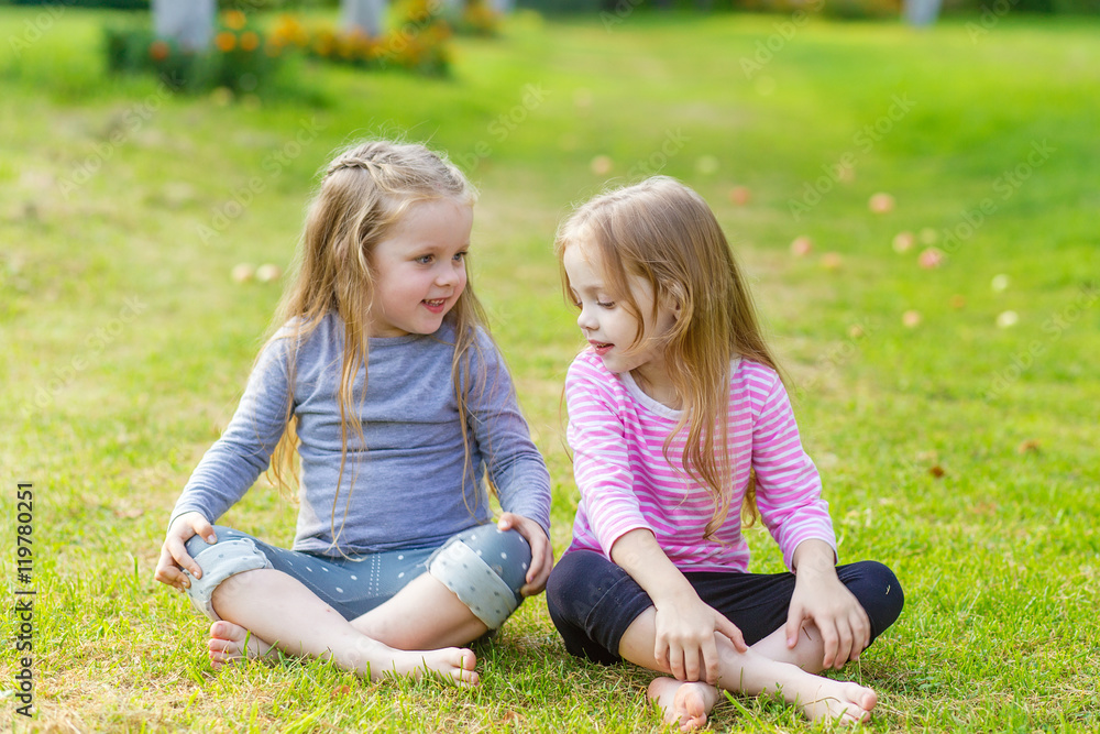 Fototapeta premium Two cute girls playing in the par