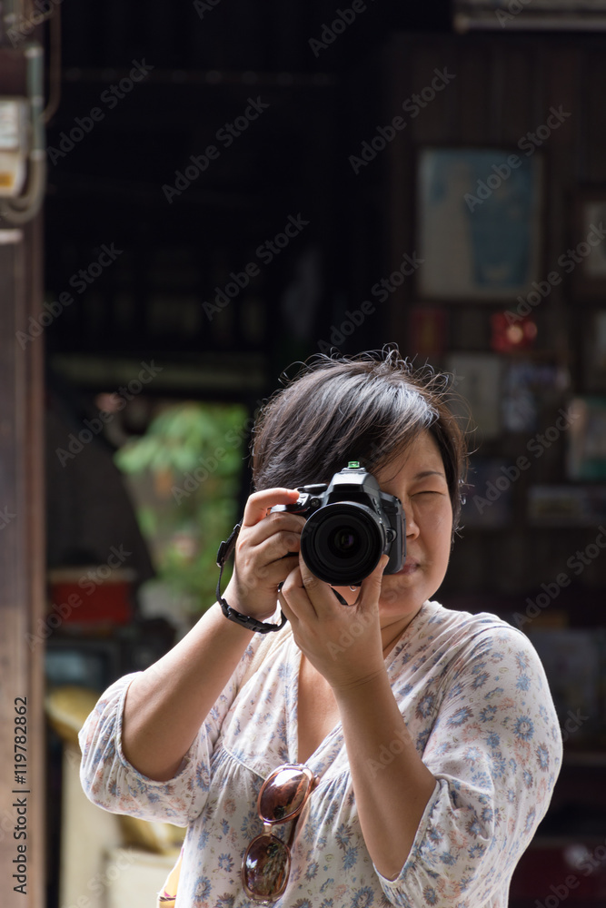 Asia woman take a photo by camera