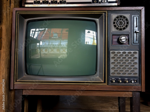 Old television with temple reflect inside.Reflection of Temple on tv screen.Television with reflection of temple and golden pagoda.