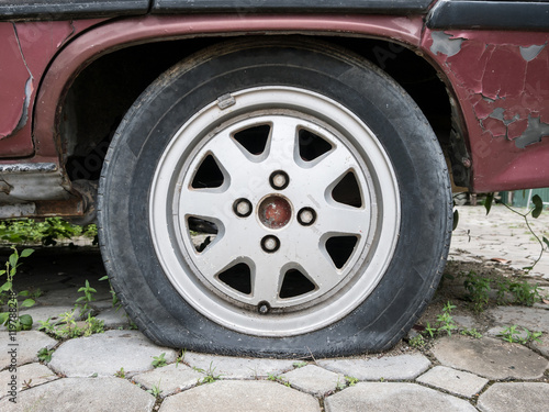 Close up Flat tire and old car