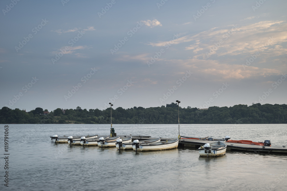 Landscape image at sunset of leisure boats moored on jetty in la
