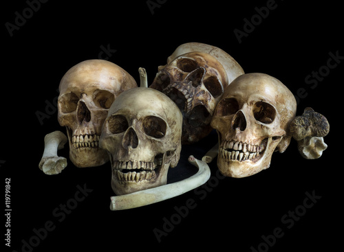 Pile of skulls and bones, isolated on black background