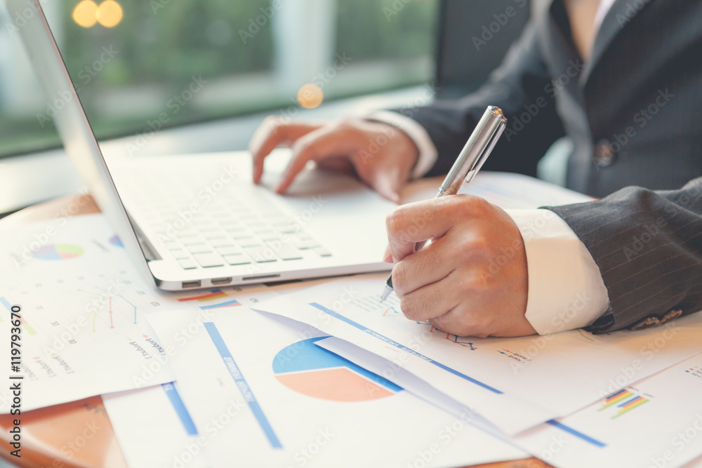 Young businessmen using Notebook and A pen