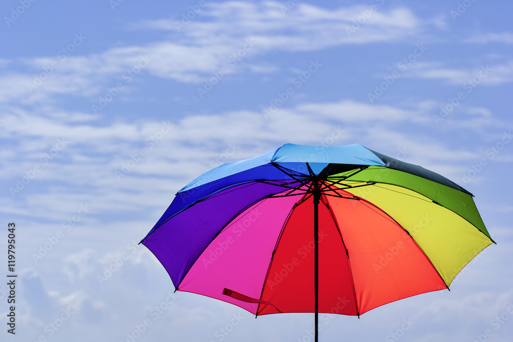 Obraz premium Beautiful Rainbow umbrella on bright sky background.