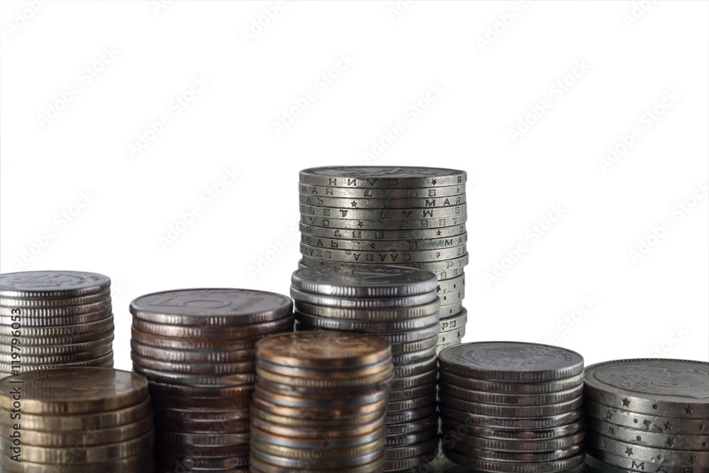 The isolated vertical piles of different coins on a white background The isolated vertical piles of different coins on a white background