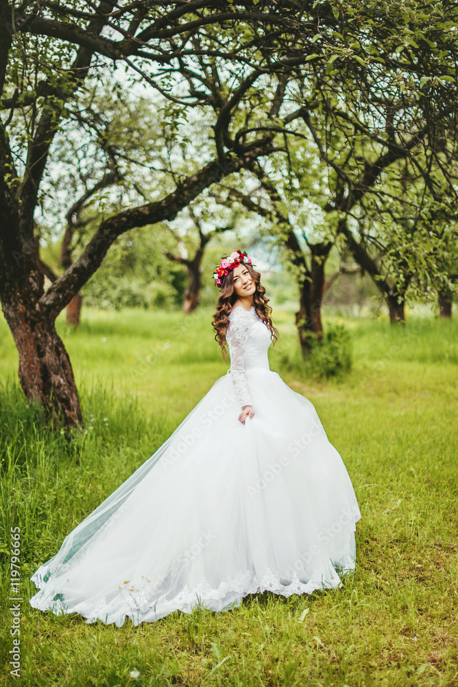 Bride in white dress in a garden
