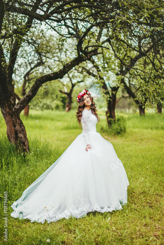 Bride in white dress in a garden © orest86
