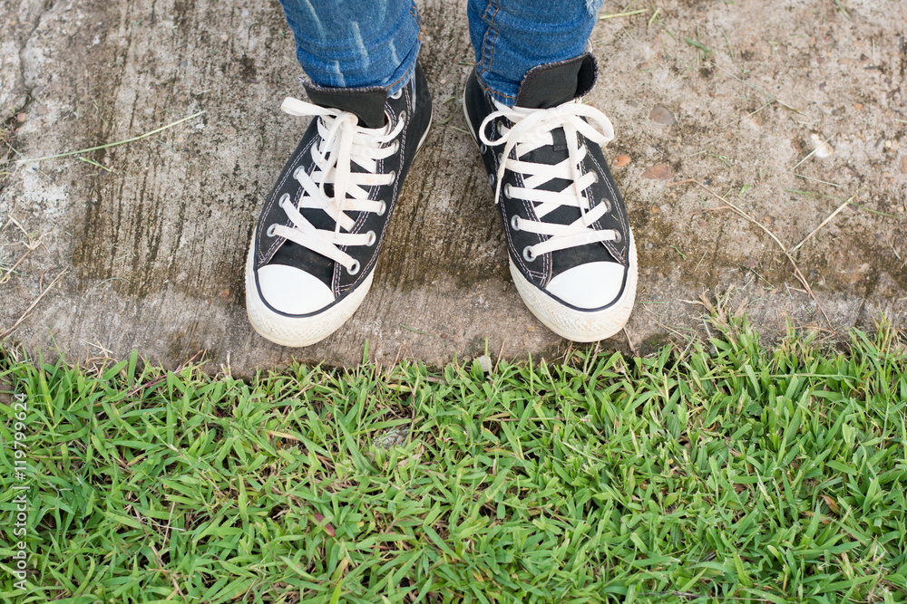 Black Sneakers shoes on road concrete Black Sneakers shoes on road concrete