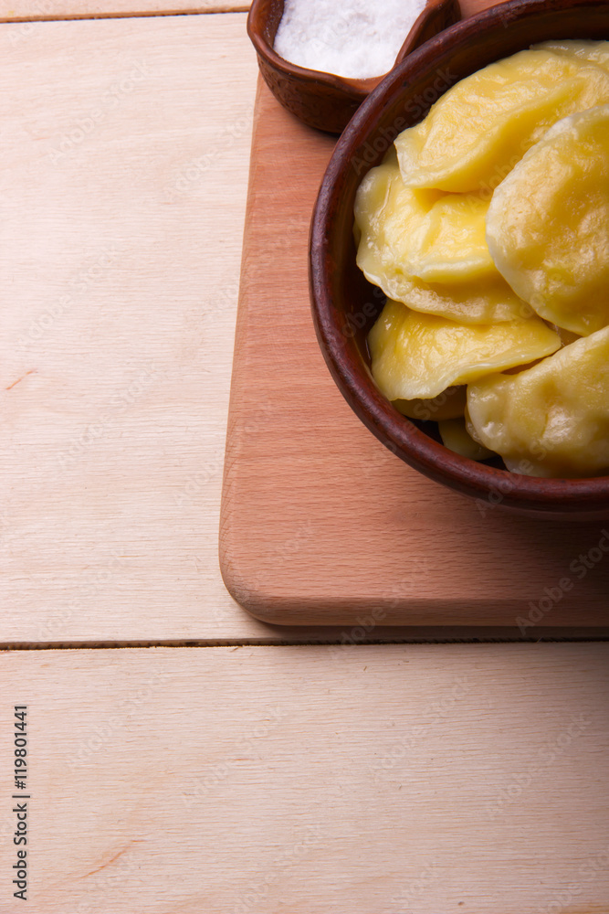VareniksCloseup.with salt- national ukrainian cuisine. clay plat VareniksCloseup.with salt- national ukrainian cuisine. clay plat