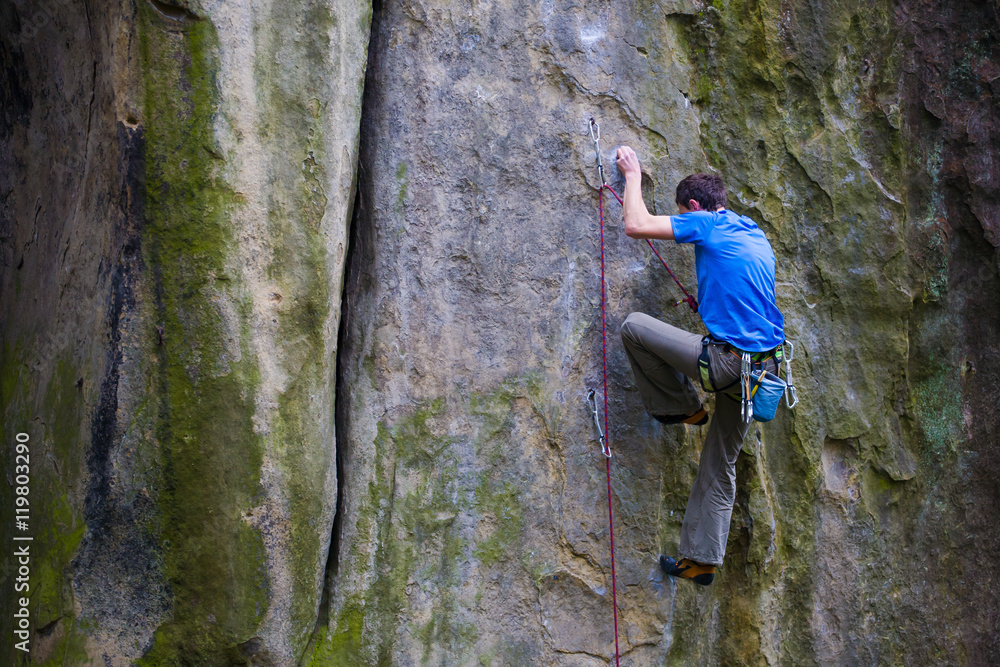 A rock climber climbs up the mountain.