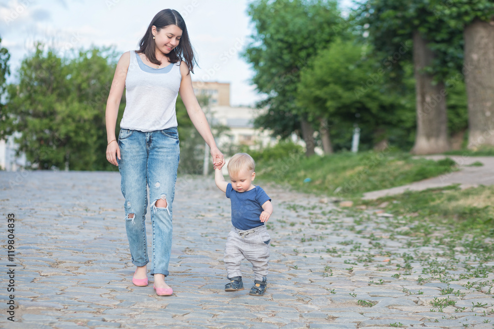 Fototapeta premium mother walking on the old road with her baby