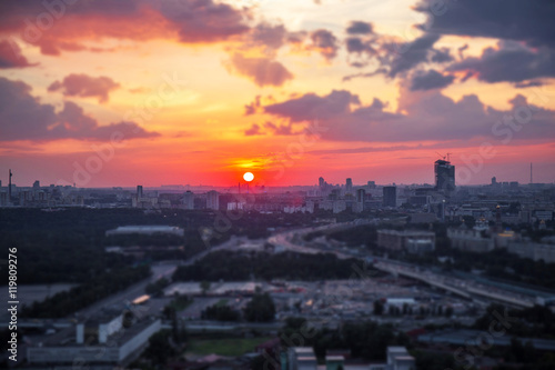 Tilt and shift view of sunset panorama of Moscow with red clouds and sun disk © boligolovag