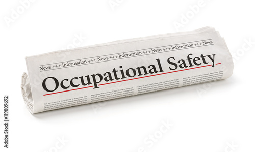 Rolled newspaper with the headline Occupational Safety