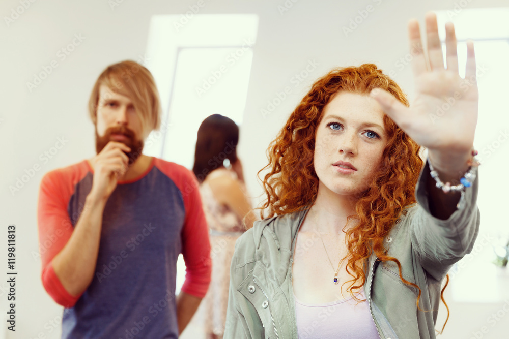 Young artists in gallery hanging painting on walls