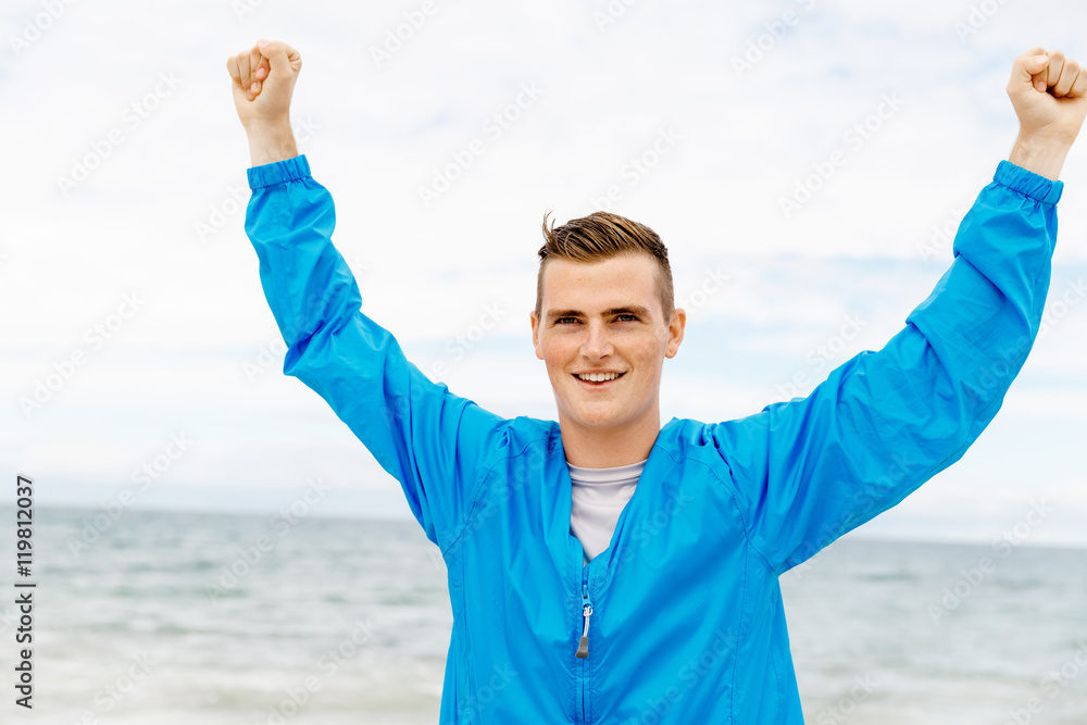 Young man in sport wear with outstretched arms Young man in sport wear with outstretched arms