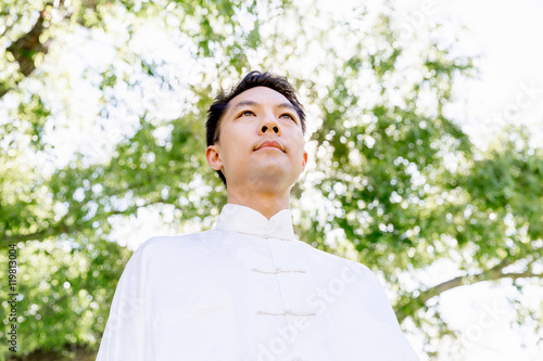 Handsome man practicing thai chi