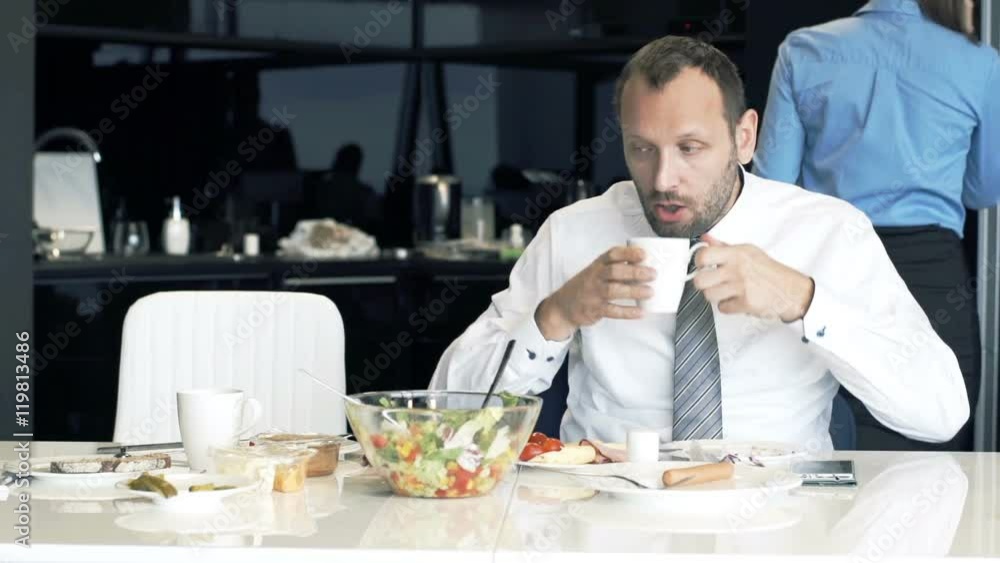 Young businesspeople during breakfast in the kitchen in the morning
Young businesspeople during breakfast in the kitchen in the morning